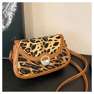 Close-up of leopard print handbag with silver round metal lock and brown leather trim