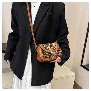 Adjustable leopard print crossbody bag styled with a professional casual outfit