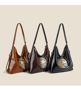 Three colors of oil-wax texture hobo bags with elephant embossed patches in a row