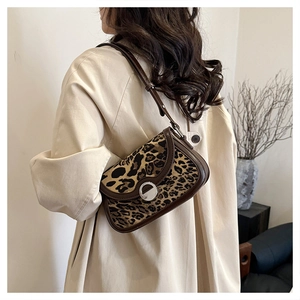 Detail of vintage leopard print shoulder bag featuring premium silver round metal buckle