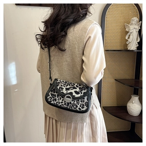 Leopard print crossbody bag with silver metal swivel lock and black trim detail