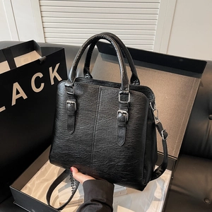 Vintage black leather handbag with lychee texture and silver buckles in a gift box