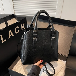 Classic black pebbled leather handbag with adjustable strap for women shown in gift box