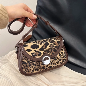 Fashionable leopard print shoulder bag with brown leather trim and silver metal buckle