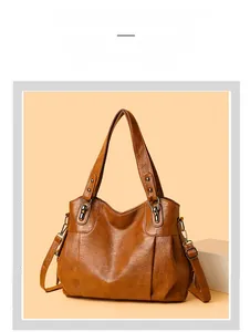 Close-up of caramel leather tote bag with soft pleated texture and vintage metal hardware