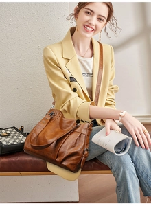 Brown PU leather tote bag detail with stylish pleated texture and spacious shoulder strap