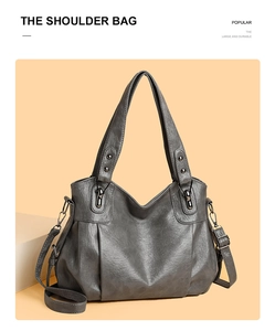 Detail of grey PU leather tote bag with adjustable shoulder strap and gunmetal hardware
