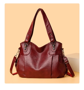 Detailed texture of burgundy PU leather tote bag with elegant decorative stitching