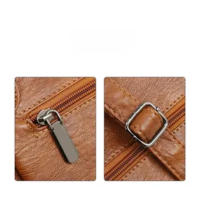 Detail of high quality brown lychee texture leather and durable silver metal zipper