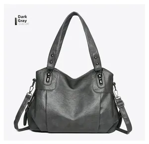 Detail view of large dark gray PU leather tote bag with silver zipper and pleat design