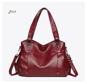 Detailed macro view of wine red synthetic leather texture with rivets and strap hooks