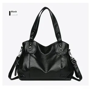 Detail of black PU leather tote with lychee texture and adjustable shoulder strap