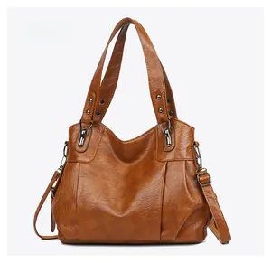 Micro side view of large brown PU leather tote bag with soft pleated texture and silver hardware