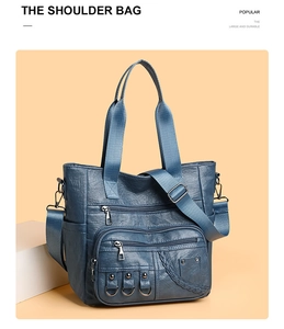 Close-up of blue PU leather tote bag with dual zipper pockets and woven handles
