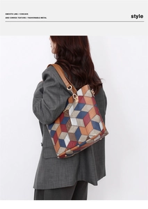 Detail of color-block 3D geometric tote bag featuring textured leather and gold hardware