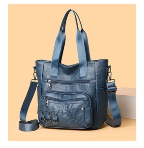 Detail of vintage dark blue tote with multi-zipper pockets and woven trim edges
