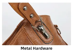 Macro view of brown PU leather texture and gunmetal hardware details with neat stitching