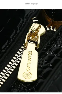 Macro shot of high-quality gold metal zipper on black crocodile texture handbag