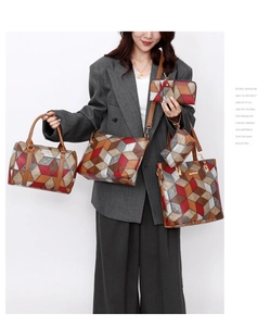 Detail view of five-piece tote bag set with geometric 3D pattern and gold hardware