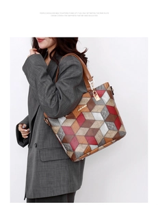 Detail of color-block tote bag with geometric pattern and metal logo on grey suit