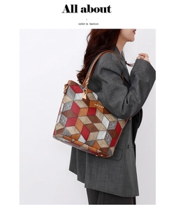 Detail of 3D geometric patchwork tote bag with gold chain strap and lock pendant