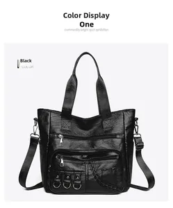 Detail view of black vintage PU tote bag with multiple zipper pockets and metal D-rings
