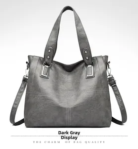 Détail du fourre-tout en cuir PU gris foncé avec surpiqûres blanches et boucles argentées