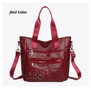 Detail of vintage burgundy tote with multiple zip compartments and woven rivet accents