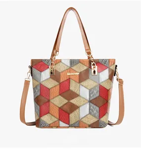 Detailed front view of color-block tote bag with 3D cube pattern and chain handles