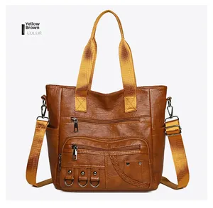 Front view of yellow brown multi-pocket tote bag with vintage texture and woven details