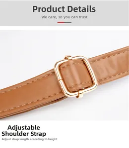 Close-up of adjustable brown leather shoulder strap with premium golden metal buckle
