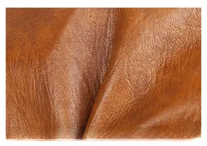 Macro shot of high-quality brown leather texture with natural lychee grain on a shoulder bag