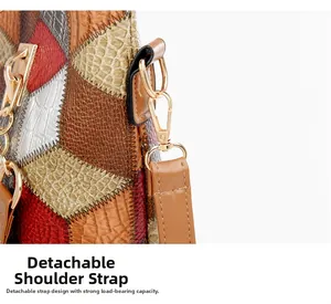 Detail of color-block embossed leather tote showing detachable strap and gold metal hook