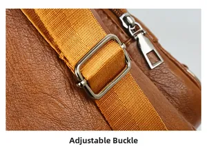 Detail of adjustable nylon strap and silver metal buckle on brown faux leather tote