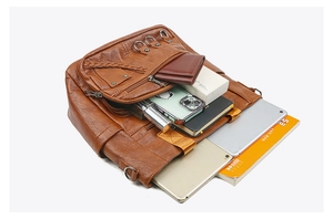 Overhead view showing a large capacity brown vintage tote bag holding a tablet and notebook