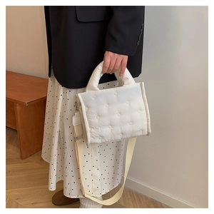 Detailansicht der weißen Stepptasche mit Sternsteppung und breitem Schultergurt