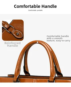 Detail view of the reinforced handle and polished oil-wax leather texture on brown tote bag