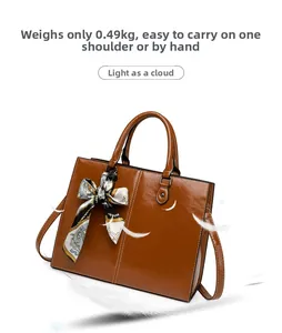 Detail view of lightweight 0.49KG brown leather tote bag with silk scarf on handle