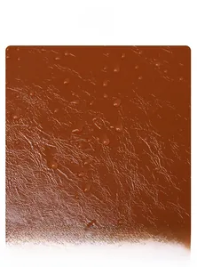 Macro shot of water-repellent brown oil wax leather texture with clear water droplets