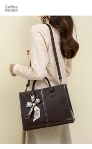 Detail of coffee brown oil wax leather tote bag with elegant silk scarf accessory