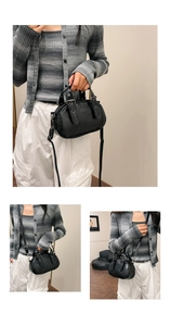 Detail of black vintage bowling bag showing faux leather texture and metallic buckle straps