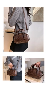 Detailed view of dark brown vintage bowling bag with metallic studs and adjustable strap