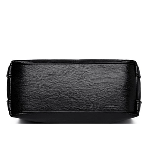 Bottom view of black pebble leather tote bag featuring durable stitching and rectangular base
