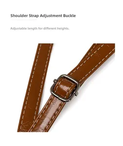 Detail of adjustable shoulder strap buckle on brown oil wax leather tote bag
