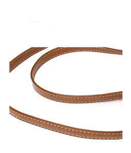 Close-up of brown oil wax leather shoulder strap with durable white reinforced stitching