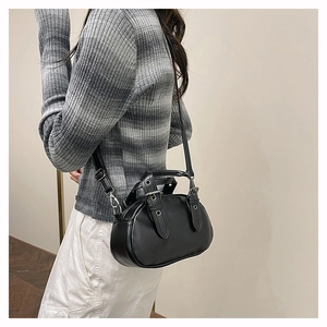 Chic vintage bowling bag with silver rivet details and metallic eyelets on side straps