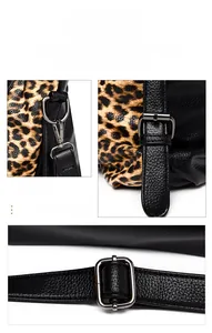 Detail of gunmetal hardware buckles and leopard print texture on a leather tote bag