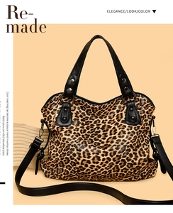 Detailed leopard print tote bag with black leather handles and metal rivet accents