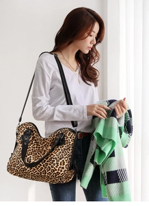 Fashionable leopard print tote bag shown as a crossbody on a model in natural light