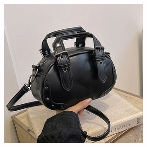 Detail of vintage black bowling bag featuring silver rivets and metal buckle hardware